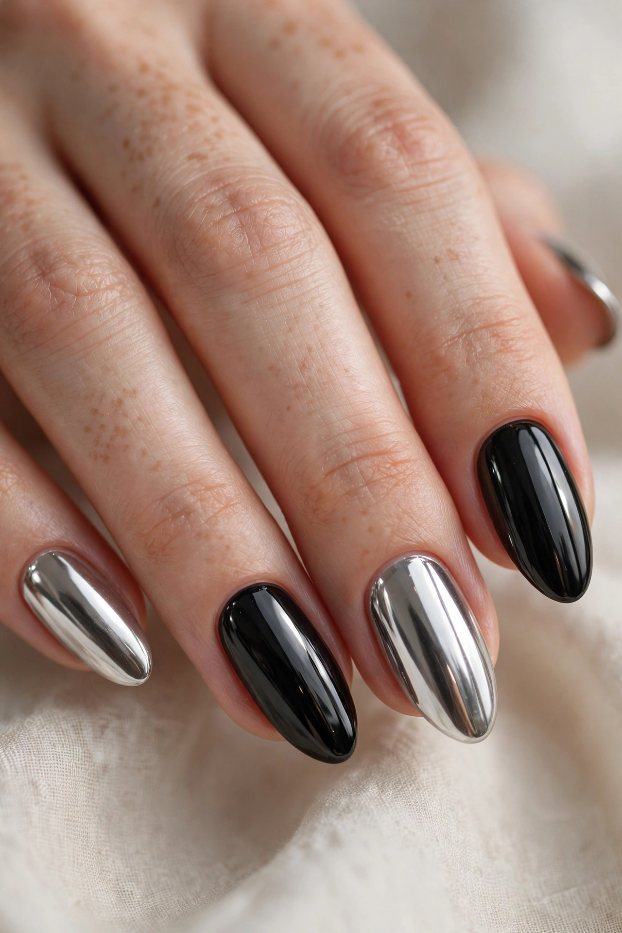 Black and silver chrome nail designs with futuristic metallic shine