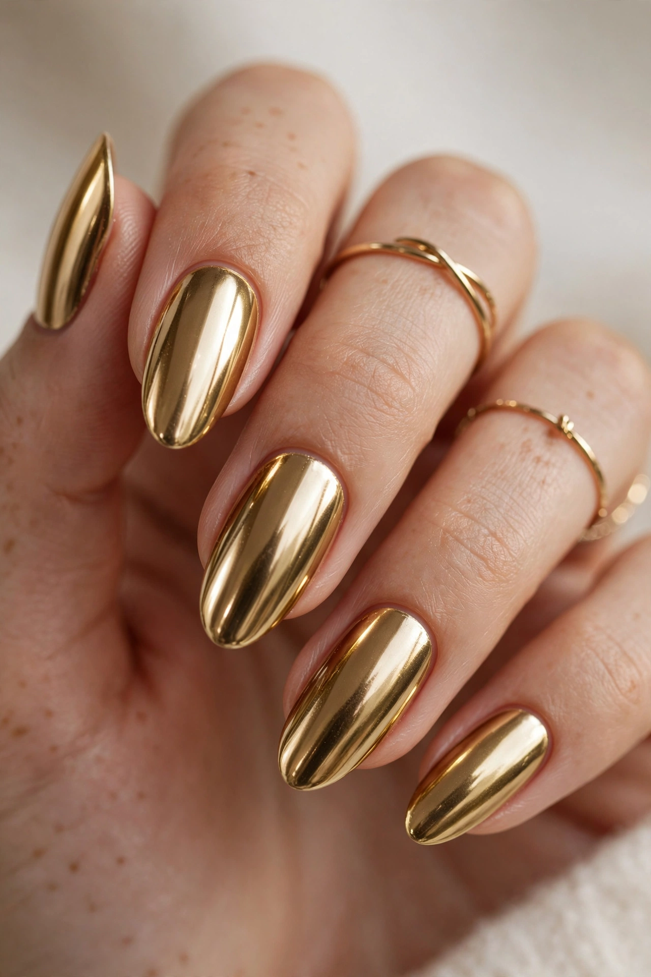 Gold chrome nail designs with a rich metallic mirror shine finish