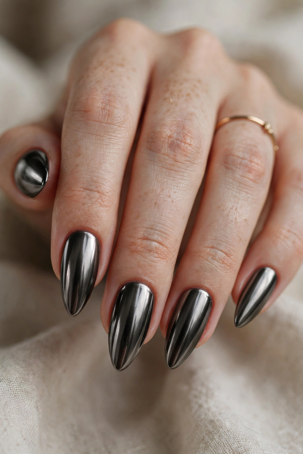 Black gunmetal chrome nail designs with a dark futuristic mirror shine