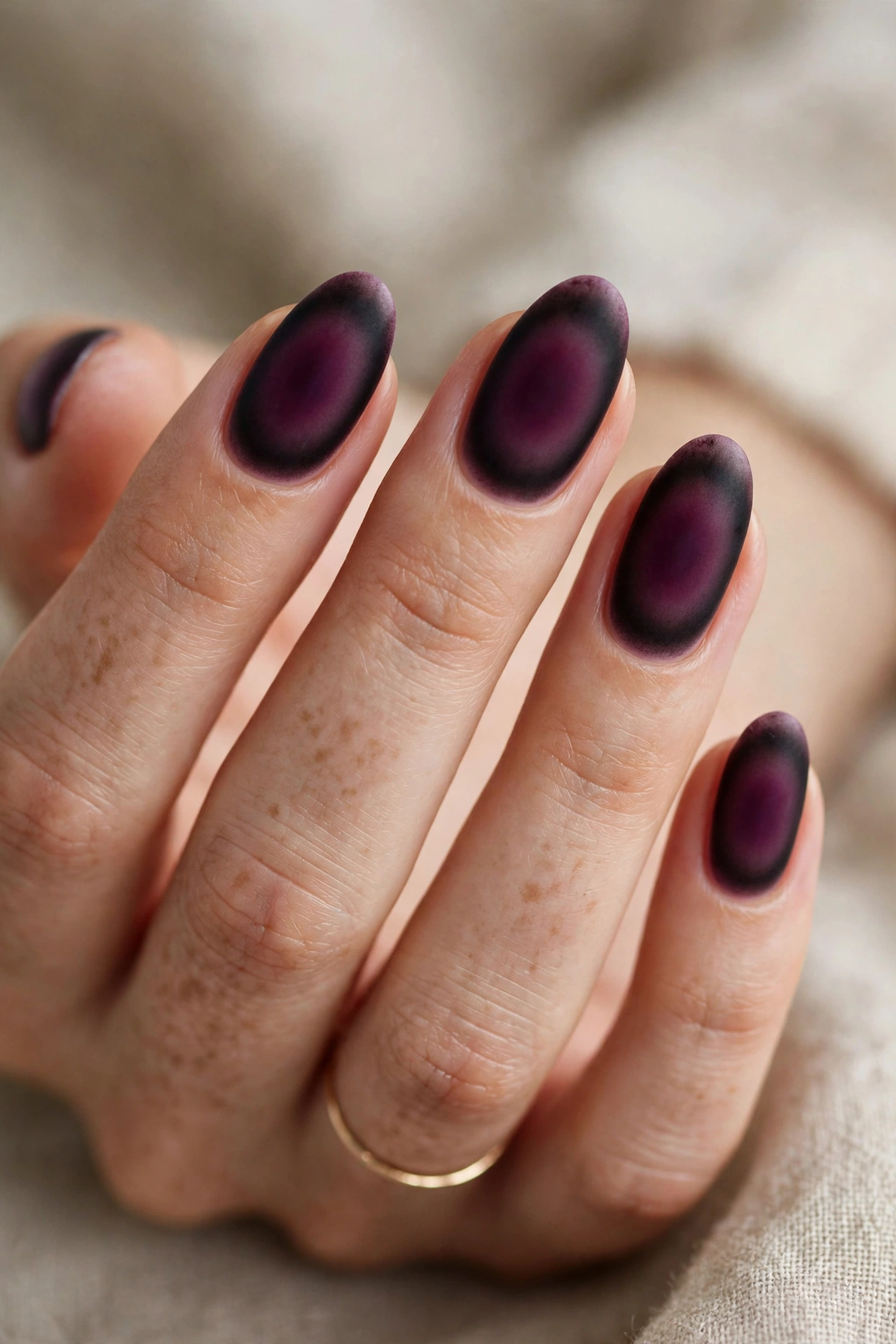 Deep plum aura fall nail designs with a soft airbrushed halo effect