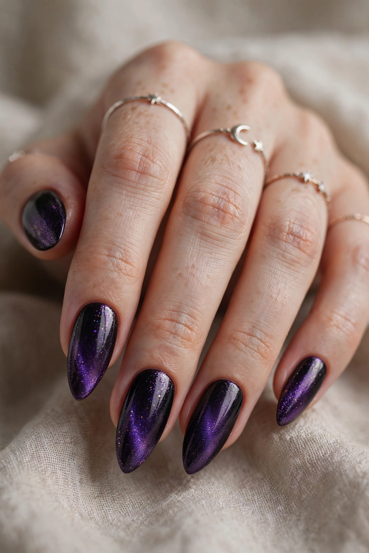 Witchy purple and black halloween nail designs with magical dark gradient