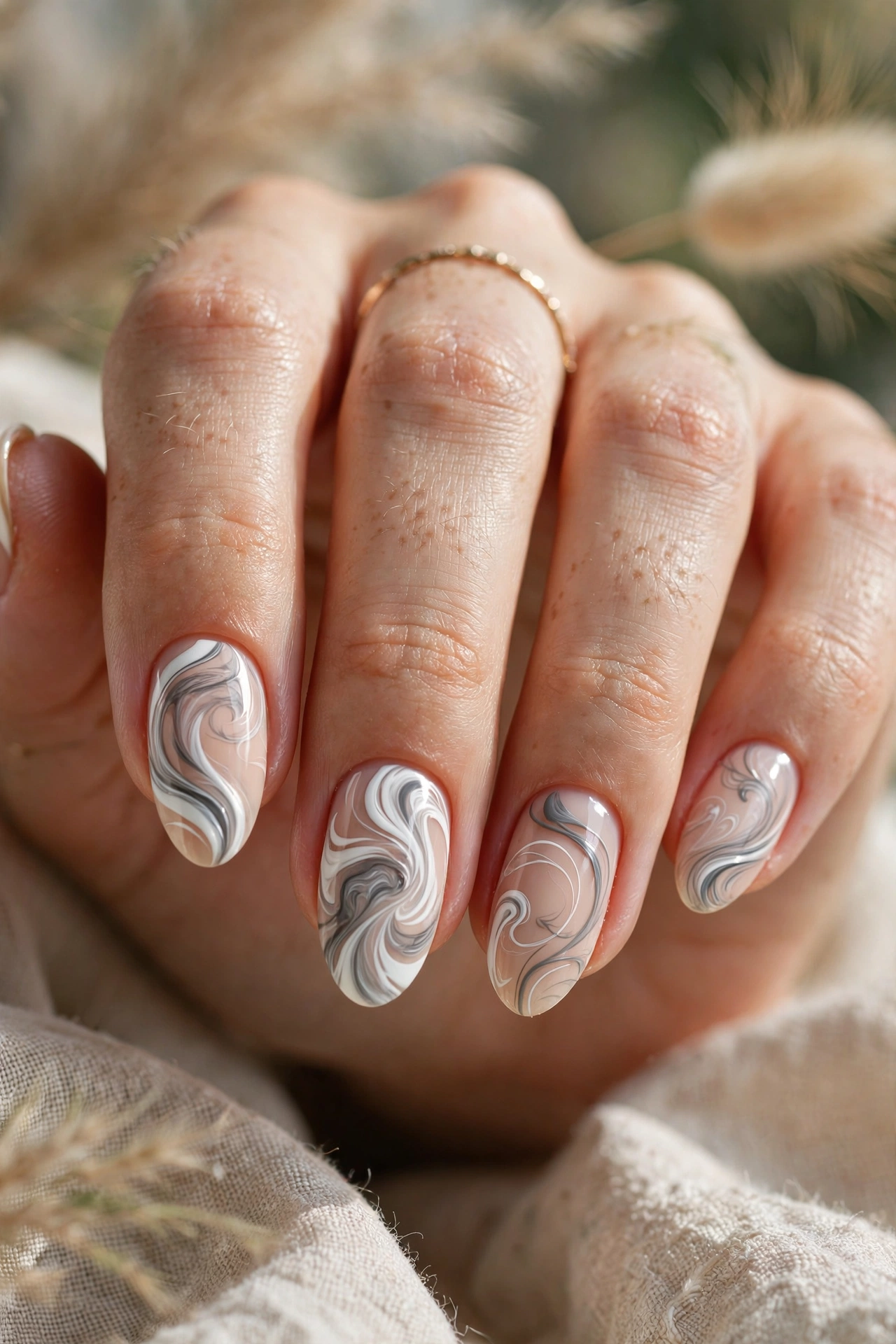White swirl nail designs with wavy line art on a nude base
